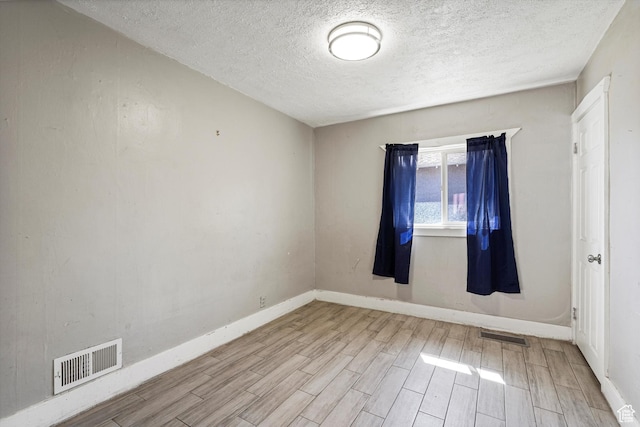 254 Franklin St, Ogden, UT 84401 - spare room with wood finished floors, a textured ceiling, and baseboards