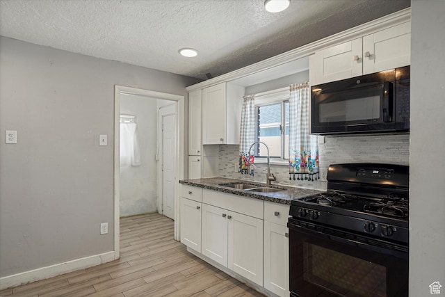 254 Franklin St, Ogden, UT 84401 - kitchen featuring black appliances, a sink, light wood-type flooring, decorative backsplash, and white cabinetry
