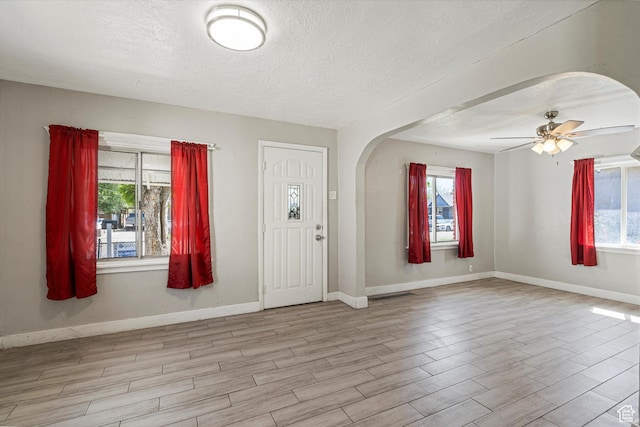 254 Franklin St, Ogden, UT 84401 - entrance foyer with wood finished floors, arched walkways, plenty of natural light, a textured ceiling, and baseboards