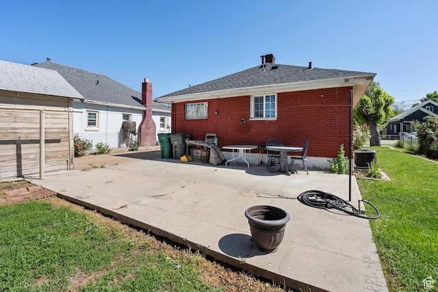 254 Franklin St, Ogden, UT 84401 - rear view of house with a patio area, cooling unit, brick siding, and roof with shingles