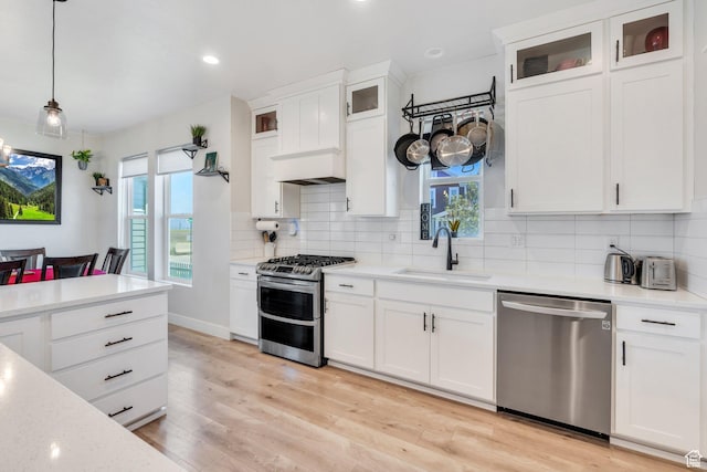 6228 W Copperhawk Dr S, South Jordan, UT 84009 - kitchen with appliances with stainless steel finishes, a sink, plenty of natural light, decorative backsplash, and recessed lighting