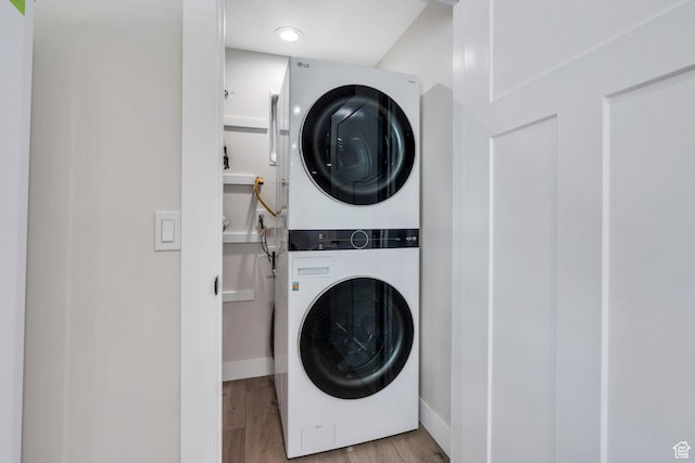 6228 W Copperhawk Dr S, South Jordan, UT 84009 - laundry room with estacked washer and dryer, wood finished floors, and baseboards