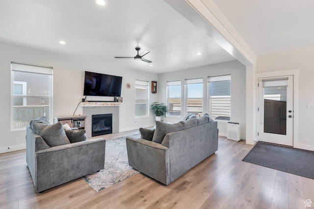 6228 W Copperhawk Dr S, South Jordan, UT 84009 - living area featuring a ceiling fan, a tiled fireplace, light wood-type flooring, baseboards, and recessed lighting