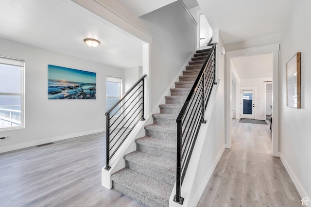 6228 W Copperhawk Dr S, South Jordan, UT 84009 - stairway featuring wood finished floors, healthy amount of natural light, and baseboards