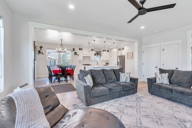 6228 W Copperhawk Dr S, South Jordan, UT 84009 - living area featuring ceiling fan, light wood-style flooring, a chandelier, and recessed lighting