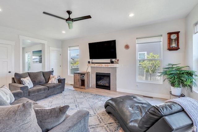 6228 W Copperhawk Dr S, South Jordan, UT 84009 - living room with a ceiling fan, plenty of natural light, wood finished floors, recessed lighting, and a tiled fireplace