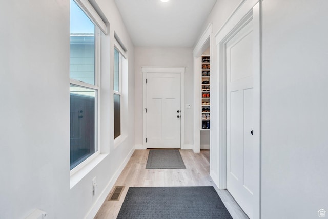 6228 W Copperhawk Dr S, South Jordan, UT 84009 - doorway with light wood-type flooring and baseboards