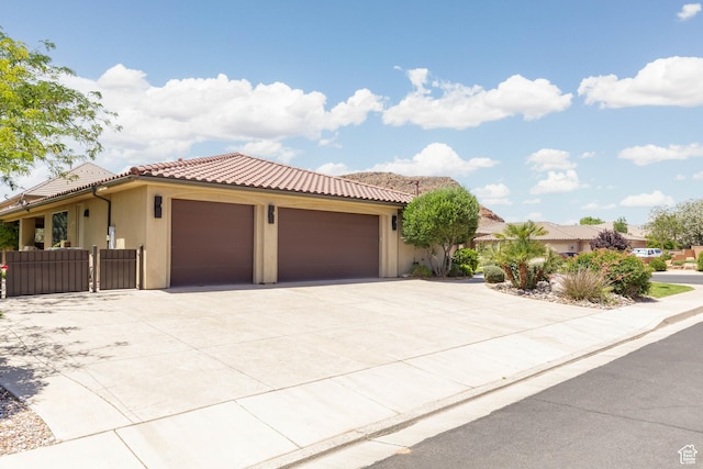 822 E Birken St, Washington, UT 84780 - view of front of home with a garage, a tile roof, concrete driveway, and stucco siding