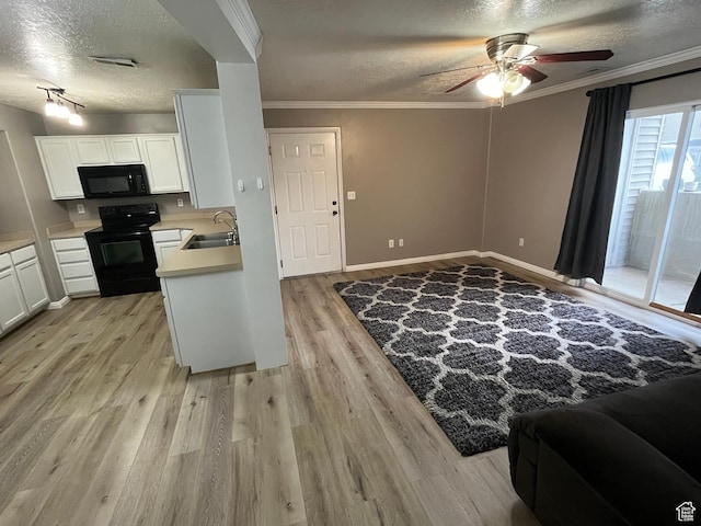 3478 E Rdg Route Rd Unit C1, Eagle Mountain, UT 84005 - kitchen with black appliances, a textured ceiling, a sink, light wood-style floors, and a ceiling fan