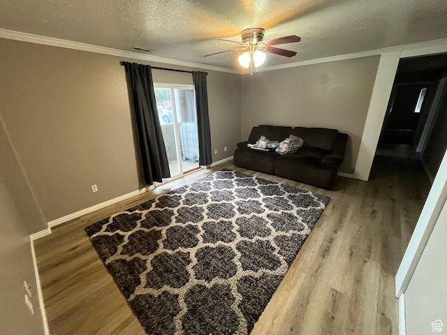 3478 E Rdg Route Rd Unit C1, Eagle Mountain, UT 84005 - living area with wood finished floors, a ceiling fan, crown molding, baseboards, and a textured ceiling