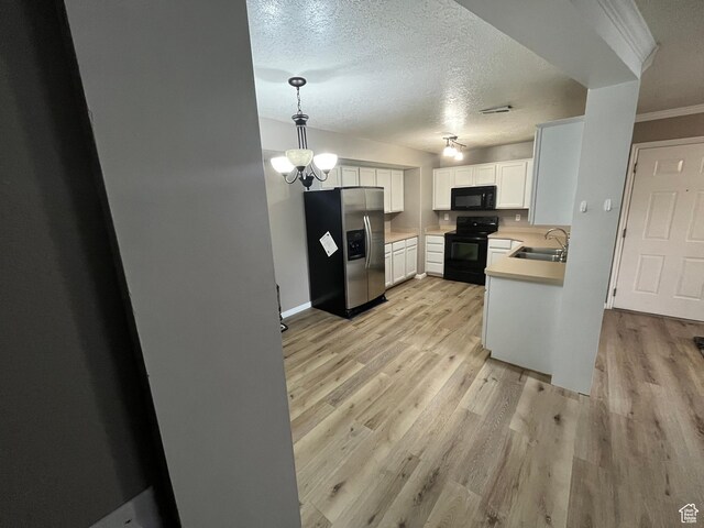 3478 E Rdg Route Rd Unit C1, Eagle Mountain, UT 84005 - kitchen featuring black appliances, a sink, light wood-style floors, light countertops, and ornamental molding