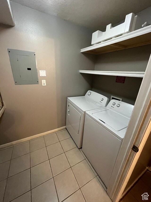 3478 E Rdg Route Rd Unit C1, Eagle Mountain, UT 84005 - laundry room featuring electric panel, independent washer and dryer, light tile patterned flooring, baseboards, and a textured ceiling