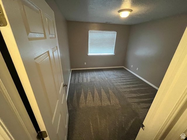3478 E Rdg Route Rd Unit C1, Eagle Mountain, UT 84005 - unfurnished bedroom featuring dark carpet, baseboards, and a textured ceiling
