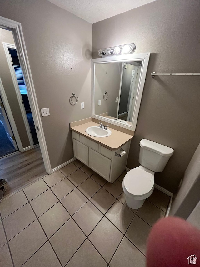 3478 E Rdg Route Rd Unit C1, Eagle Mountain, UT 84005 - half bath featuring toilet, tile patterned flooring, vanity, and baseboards