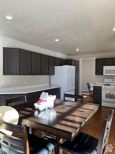 438 E Parowan Way, Draper, UT 84020 - kitchen with white appliances, a textured ceiling, light countertops, recessed lighting, and wood finished floors