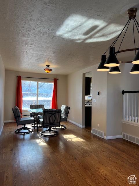 438 E Parowan Way, Draper, UT 84020 - dining room featuring wood finished floors, a textured ceiling, and baseboards