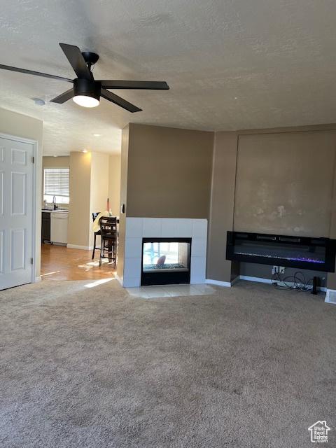 438 E Parowan Way, Draper, UT 84020 - unfurnished living room featuring a fireplace, ceiling fan, baseboards, carpet floors, and a textured ceiling