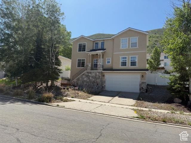 438 E Parowan Way, Draper, UT 84020 - traditional home with concrete driveway, an attached garage, stone siding, and stucco siding