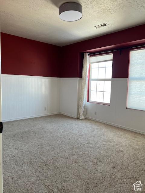 438 E Parowan Way, Draper, UT 84020 - carpeted spare room featuring a textured ceiling and wainscoting