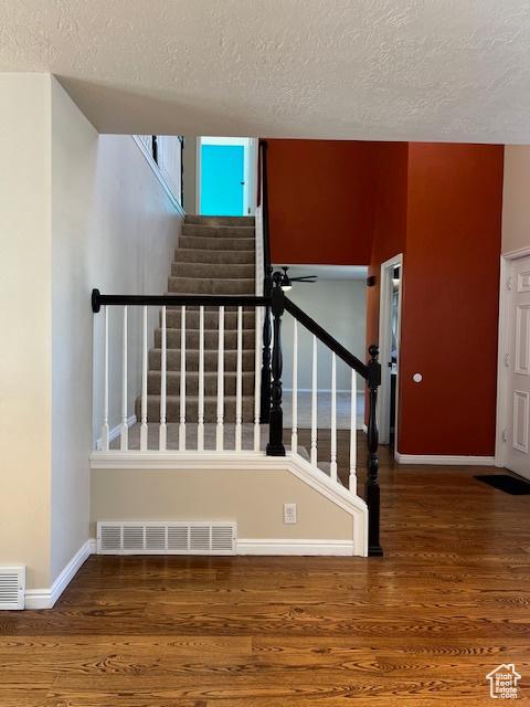 438 E Parowan Way, Draper, UT 84020 - stairway with a textured ceiling, wood finished floors, and baseboards