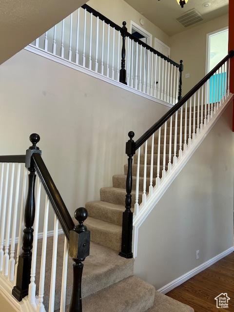 438 E Parowan Way, Draper, UT 84020 - stairs featuring wood finished floors, a towering ceiling, and baseboards