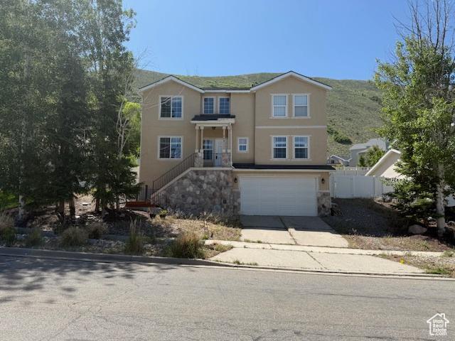 438 E Parowan Way, Draper, UT 84020 - view of front of property with stucco siding, concrete driveway, an attached garage, and stone siding