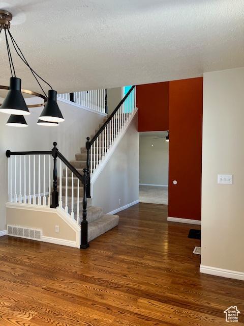 438 E Parowan Way, Draper, UT 84020 - stairs featuring baseboards, wood finished floors, and a textured ceiling