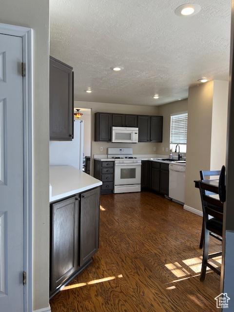 438 E Parowan Way, Draper, UT 84020 - kitchen featuring white appliances, a textured ceiling, dark wood-style floors, light countertops, and recessed lighting