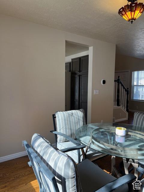 438 E Parowan Way, Draper, UT 84020 - dining area with a textured ceiling, wood finished floors, baseboards, and stairs