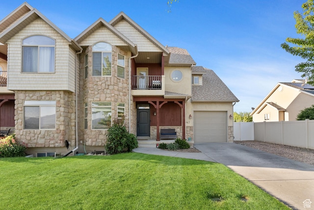 2047 E 1850 S, Spanish Fork, UT 84660 - view of front facade featuring stone siding, a balcony, concrete driveway, and a garage