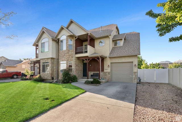 2047 E 1850 S, Spanish Fork, UT 84660 - view of front facade with stone siding, a balcony, a shingled roof, concrete driveway, and an attached garage