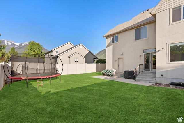 2047 E 1850 S, Spanish Fork, UT 84660 - view of yard with a trampoline, a mountain view, entry steps, and a patio