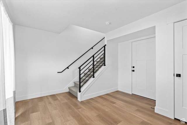 3466 S Peebles Ct E, South Salt Lake, UT 84115 - entrance foyer featuring light wood-style flooring, stairway, and baseboards