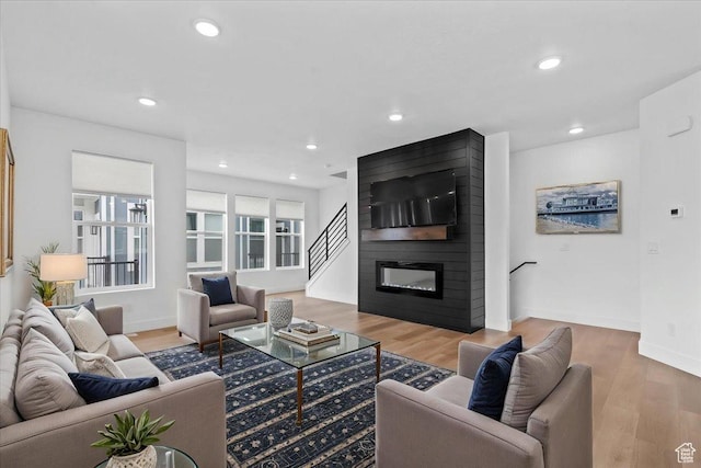 3466 S Peebles Ct E, South Salt Lake, UT 84115 - living room featuring wood finished floors, a large fireplace, recessed lighting, and baseboards