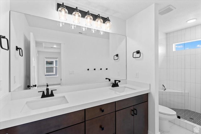3466 S Peebles Ct E, South Salt Lake, UT 84115 - bathroom featuring toilet, double vanity, and a tile shower