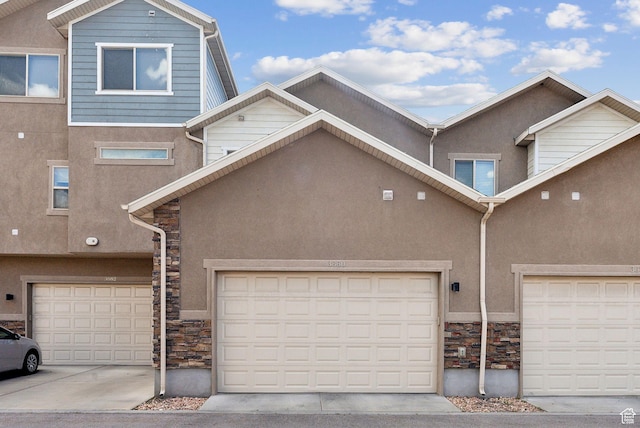 3880 S 1580 W Unit 224, West Valley City, UT 84119 - view of property with stone siding, stucco siding, and driveway