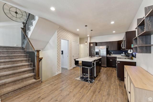 3880 S 1580 W Unit 224, West Valley City, UT 84119 - kitchen with appliances with stainless steel finishes, a sink, light countertops, open shelves, and dark brown cabinets