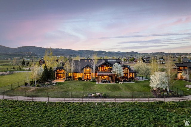 7778 N Greenfield Dr, Park City, UT 84098 - back of house at dusk featuring a patio and a mountain view