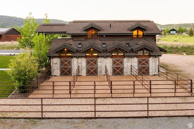 7778 N Greenfield Dr, Park City, UT 84098 - view of front of property featuring an exterior structure, an outbuilding, a shingled roof, and a mountain view