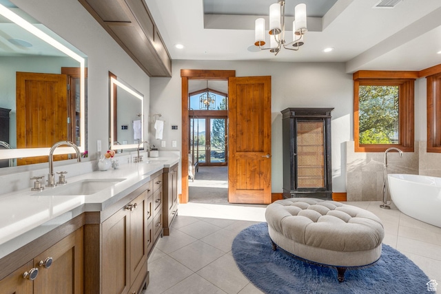 7778 N Greenfield Dr, Park City, UT 84098 - full bathroom with tile patterned floors, double vanity, a soaking tub, recessed lighting, and a chandelier