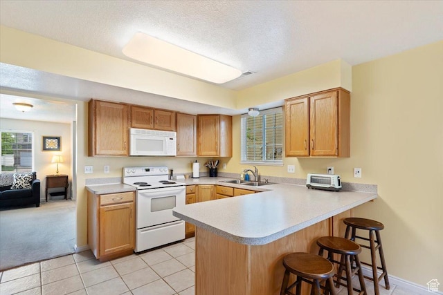 1338 E 6125 S, South Ogden, UT 84405 - kitchen with white appliances, a sink, a kitchen breakfast bar, a peninsula, and light countertops