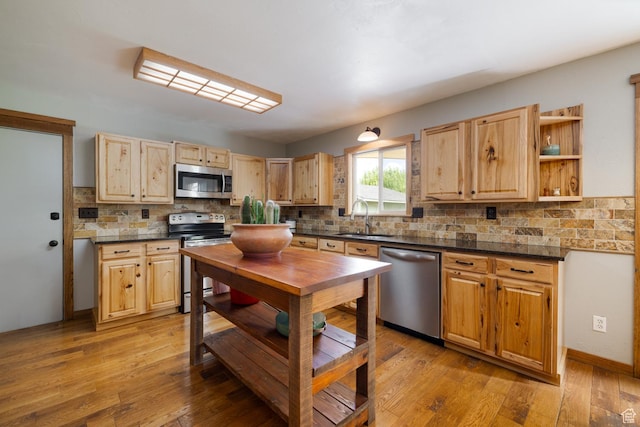 2155 W 900 N, Maeser, UT 84078 - kitchen featuring appliances with stainless steel finishes, a sink, dark countertops, and backsplash