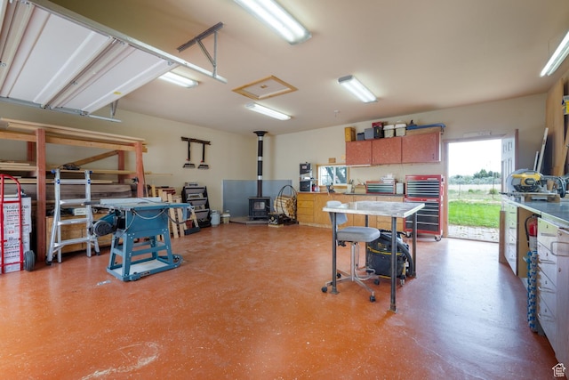 2155 W 900 N, Maeser, UT 84078 - garage featuring a wood stove and a workshop area