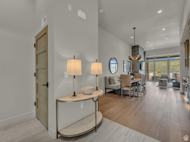 6417 Double Deer Loop, Park City, UT 84098 - living area featuring wood finished floors, a towering ceiling, recessed lighting, a chandelier, and baseboards