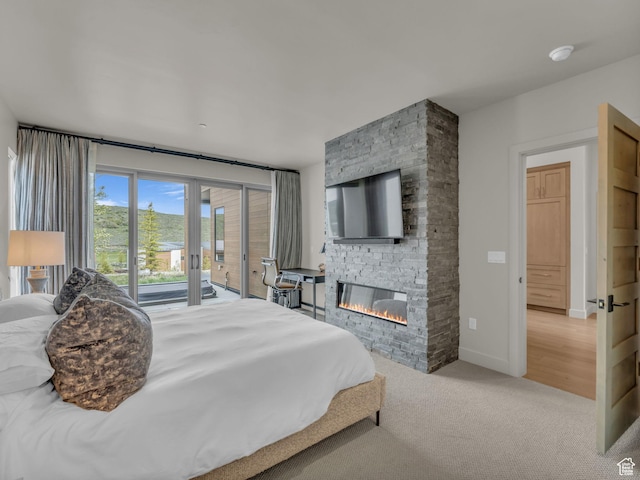 6417 Double Deer Loop, Park City, UT 84098 - carpeted bedroom with access to outside, a stone fireplace, and baseboards