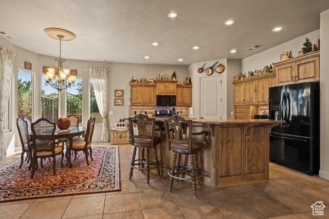 1618 N 775 W, Washington, UT 84780 - kitchen featuring black appliances, a chandelier, brown cabinetry, recessed lighting, and a kitchen breakfast bar
