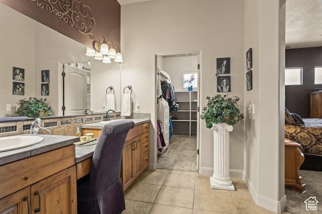 1618 N 775 W, Washington, UT 84780 - ensuite bathroom featuring vanity, tile patterned flooring, a spacious closet, and baseboards