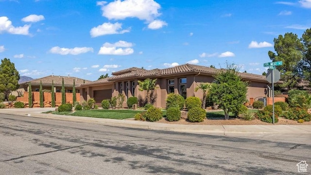 1618 N 775 W, Washington, UT 84780 - mediterranean / spanish house featuring a garage, stucco siding, a tiled roof, and concrete driveway