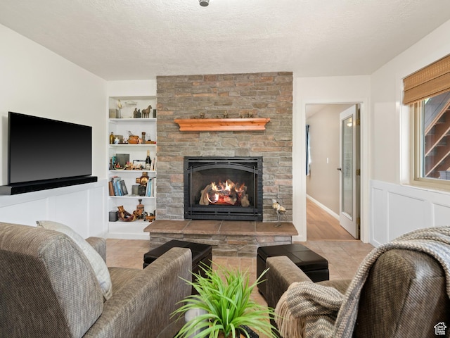 4253 S Spring Rd E, Ogden, UT 84403 - living room featuring a stone fireplace, built in shelves, and a textured ceiling