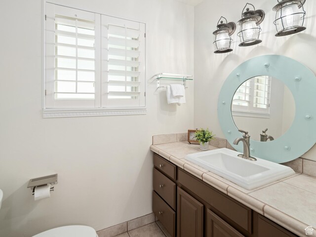 4253 S Spring Rd E, Ogden, UT 84403 - half bathroom featuring toilet, plenty of natural light, vanity, and tile patterned flooring